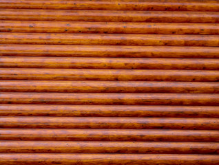 rough wooden timber background , brown and orange log wall texture , beam walls close up for building design