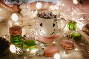 Colorful macaroons and sweets, coffe with marshmallow over white. Winter and Christmas food background