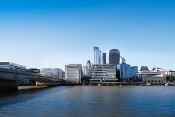 City of London, United Kingdom 6th July 2019: London skyline seen from south bank, river Thames in foreground on summer day