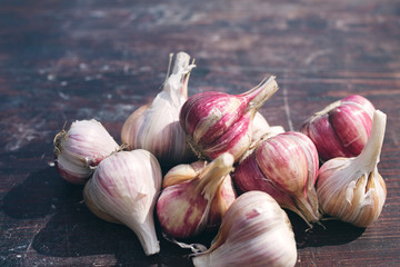 Fresh garlic crop on old wooden table, close-up
