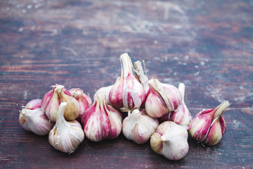 Fresh garlic crop on old wooden table, close-up
