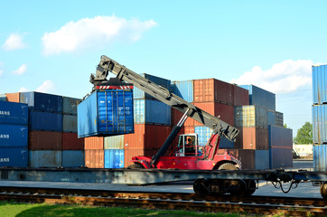 Shipping container loading by richtracker on the freight rail car at logistic warehouse port. Ocean...