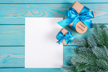 Christmas gift with noteChristmas background with letter, gifts and Christmas tree. Copy space