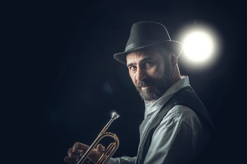 jazz trumpet player on a dark background.