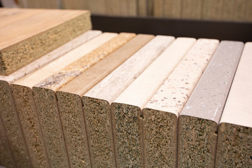 Different types of wooden samples materials for a kitchen - example set for furniture manufacture. Photo with selective focus