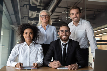 Portrait of smiling multiethnic businesspeople posing in office
