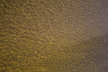 the structure of water in shades of sunlight, the manifestation of texture in the form of abstraction