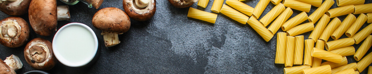 pasta Tortiglioni and ingredients for mushroom sauce (Italian main course Maccheroni, Rigatoni) menu concept. food background. top view. copy space