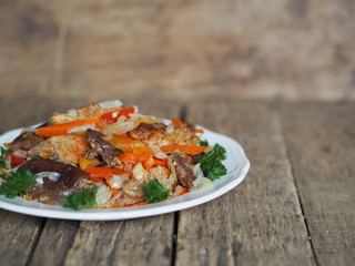 rabbit stew with vegetables on an ancient rustic wooden table