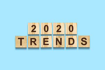 2020. Trends. Words on wooden blocks. Isolated on a blue background. Business.