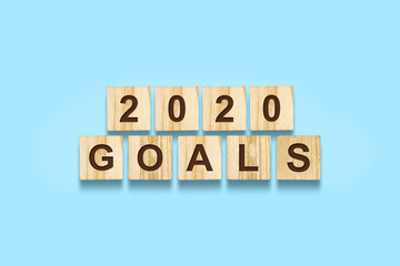 2020. Goals. Words on wooden blocks. Isolated on a blue background. Business. Action.