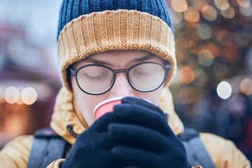 Man drinking hot wine in Christmas market