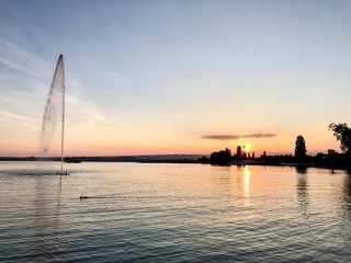 water fountain with a pristine lake sunset 