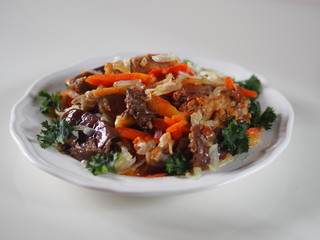 rabbit stew with vegetables on a white table