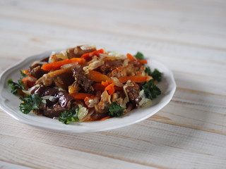rabbit stew with vegetables on a white table
