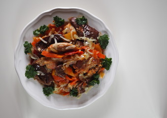 rabbit stew with vegetables on a white table