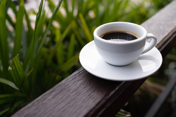 Hot coffee cup on balcony with nature background