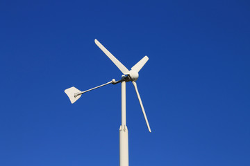 Wind turbine against blue sky