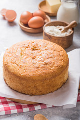 Homemade  Soft and lite delicious sponge cake with ingredients: eggs flour milk on stone concrete table. Bakery background concept.