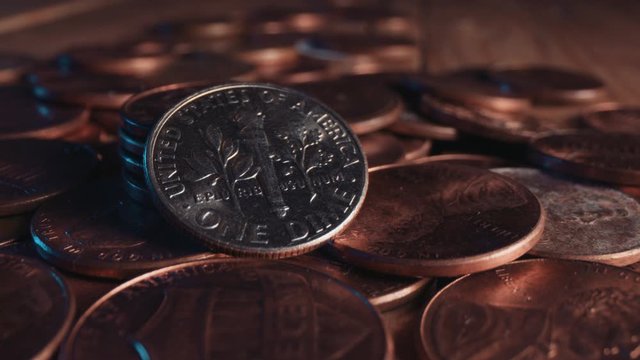 A shiny American dime stands out among pennies