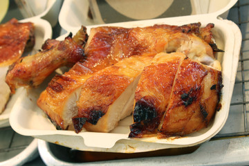 Grilled chicken slice into pieces and put in a foam box for sale as street food in Bangkok,Thailand