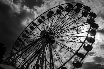 Ferris wheel against stormy sky