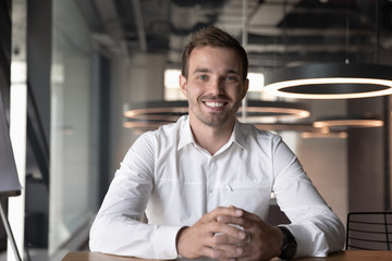 Obraz premium Portrait of smiling male employee posing in office