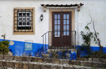 Typical bright facade of the house in Portugal. Obidos.