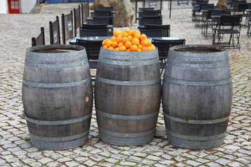 orange barrel in street cafe