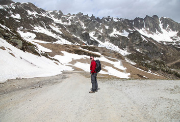 Naklejka premium Tourist hiking in snow mountains