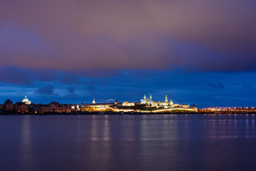 Kazan Kremlin with Presidential Palace, Annunciation Cathedral, Soyembika Tower, Qolsharif Mosque from the embankment near the center family and marriage with the bright blue sky at night.