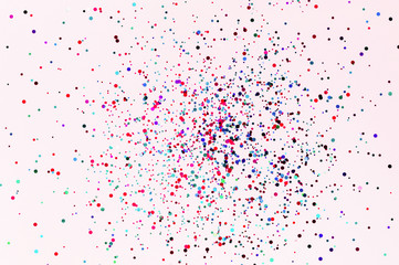 Glitter flying sparkles on pink pastel trendy background. Festive backdrop for graphic design projects.