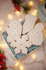 Christmas ginger bread - snowflake, mitten, hat in box on white background. Top view, flat lay.