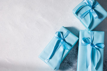 present box with blue bow isolated on gray background