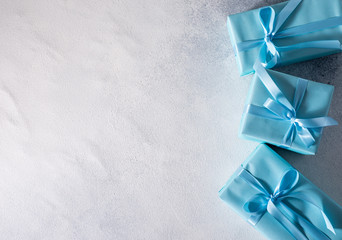 present box with blue bow isolated on gray background