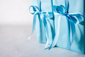 present box with blue bow isolated on gray background