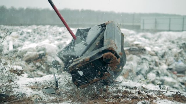 A man destroys old TV, using a hammer. Man with a hammer shatters the TV screen.