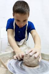 Fototapeta premium Boy at pottery wheel