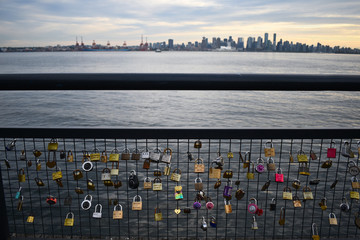 Love locks fence in North Vancouver with Vancouver skyline sunset