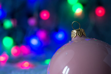 christmas ball on a color lights background