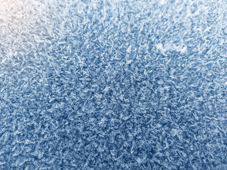 Ice crystals, close-up frost in the morning, frosty background, frost on the ground. Rime structure of snow. Focus in the center.
