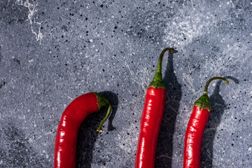 red hot chili peppers on a gray stone background