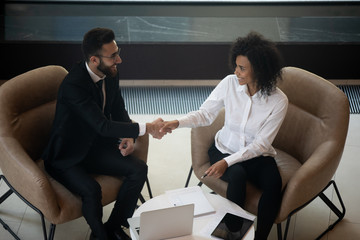 Top view multiracial business partners handshake at meeting