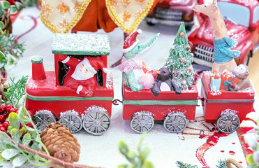 Christmas toy train with Santa Claus and various animals.