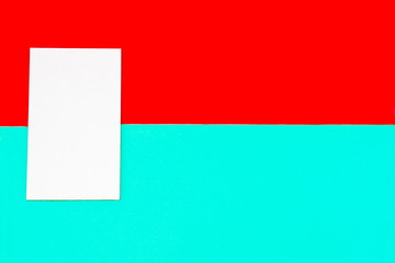 Geometric square on colored backgrounds closeup. A figure on a red and mint background