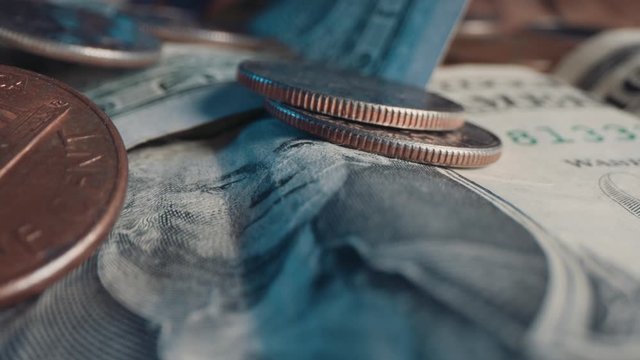 US dollar bills & quarter coins, change on table