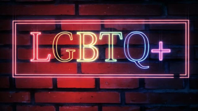 LGBTQ plus neon sign blinks and sparkles with stars on a brick wall background 4k