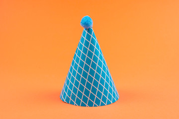 Colorful birthday caps on orange background.