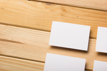 Business card blank on wooden background. Corporate Stationery, Branding Mock-up. Creative designer desk. Flat lay. Copy space for text