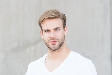 Obraz premium Love yourself. portrait of male attractiveness. young sexy guy gray background. unshaved macho man. summer male fashion. student unshaven face stylish hairstyle. Bearded man casual style